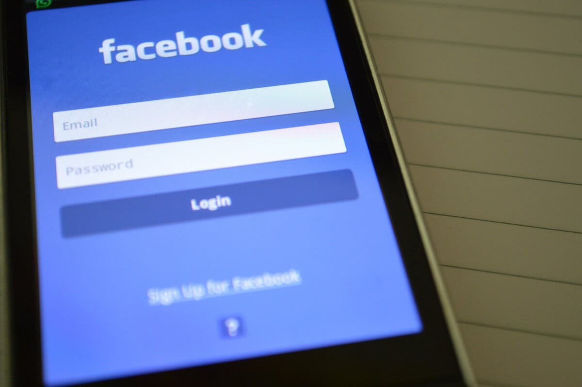A phone showing the Facebook login screen.