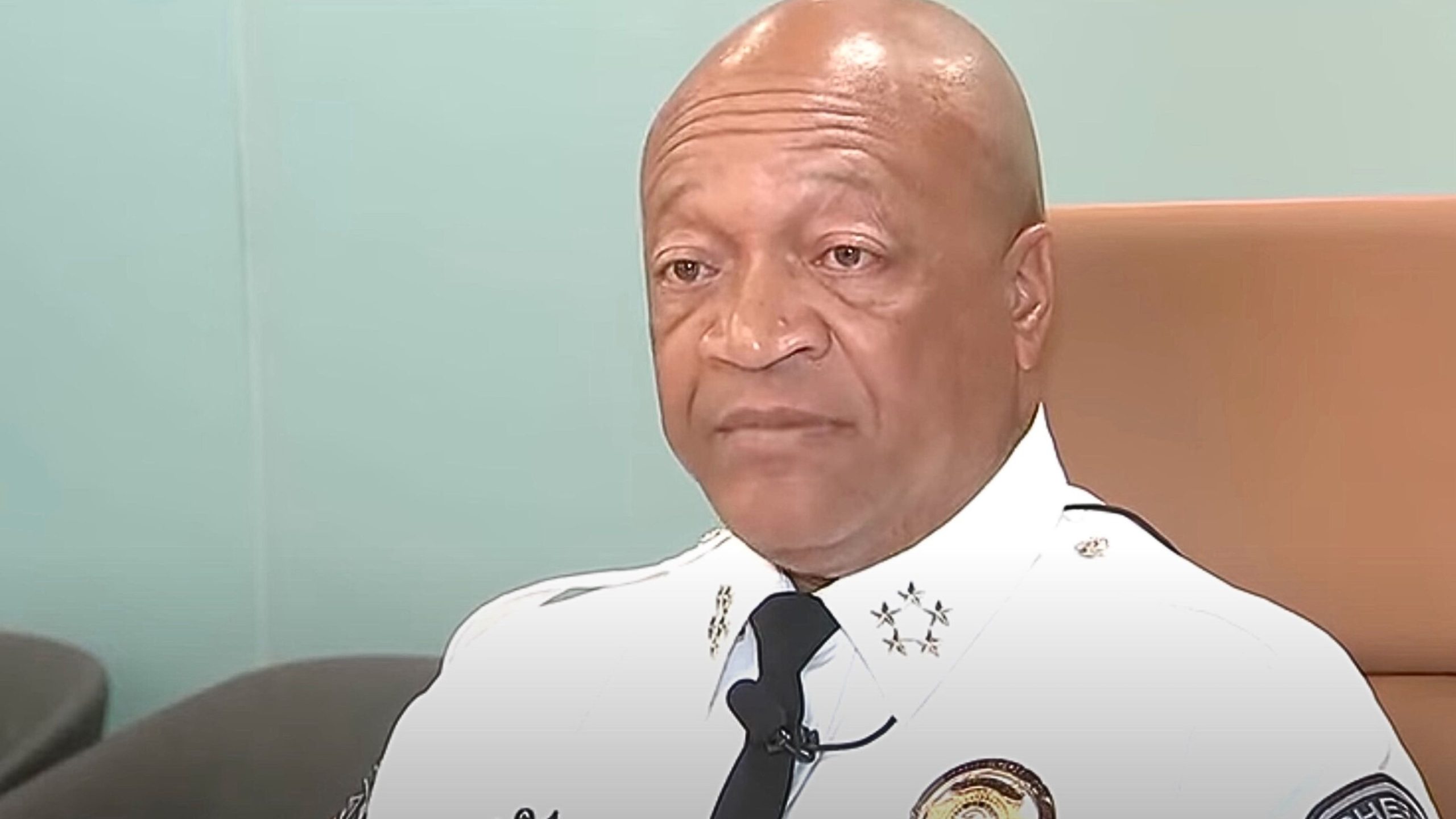 Sheriff Owens in a police uniform seated in an office.