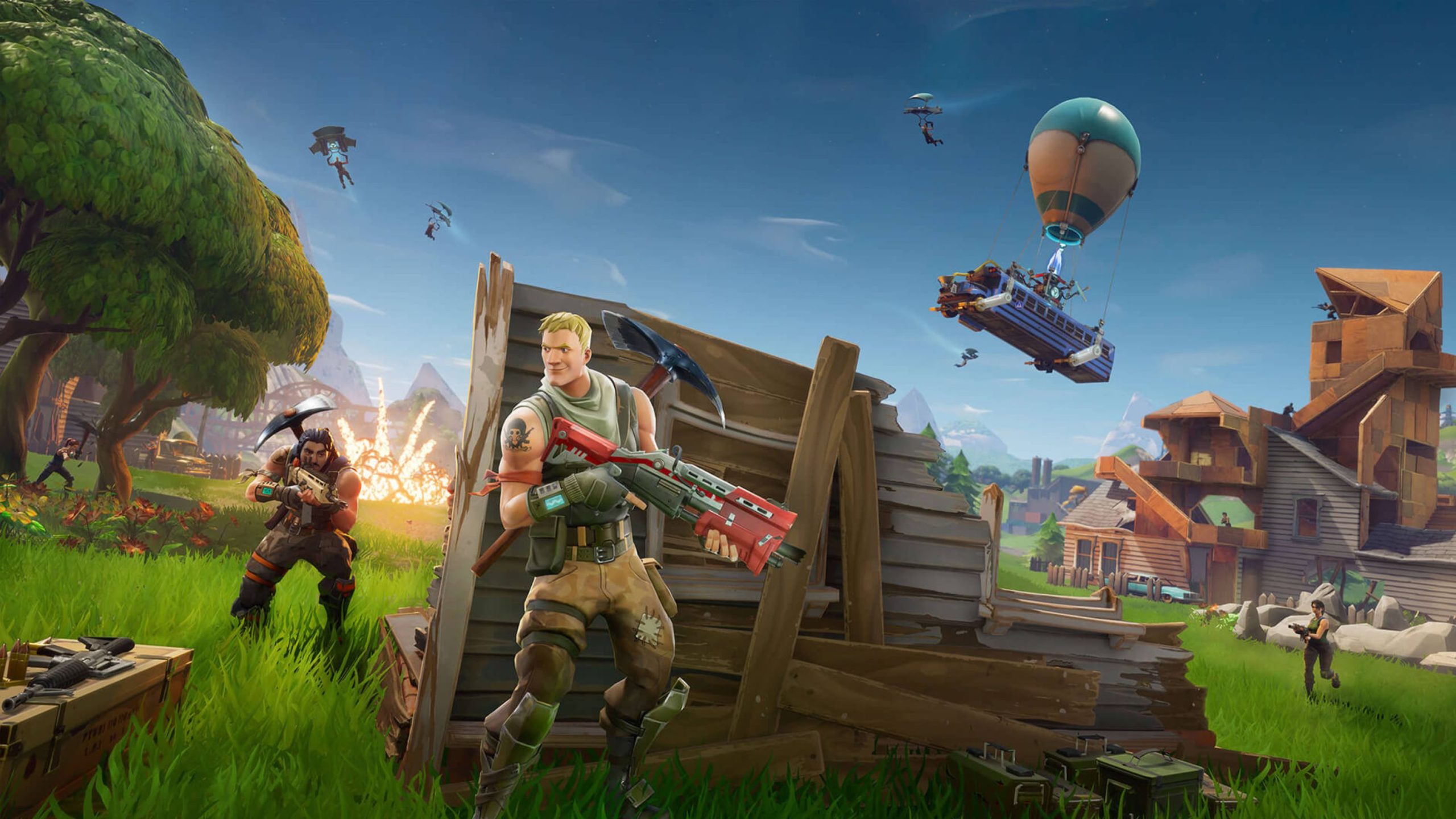 Video game scene from Fortnite depicting characters with weapons and structures, a floating bus with a balloon, and players parachuting from the sky in a colorful landscape.