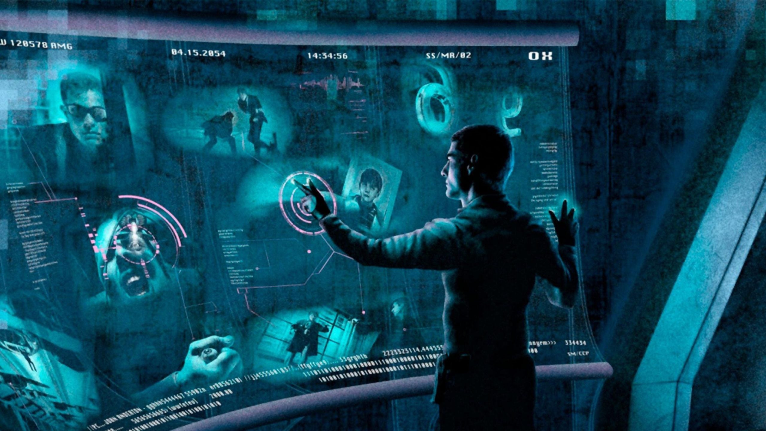 A person interacts with a futuristic, transparent computer interface displaying various images and data in a blue-toned environment.