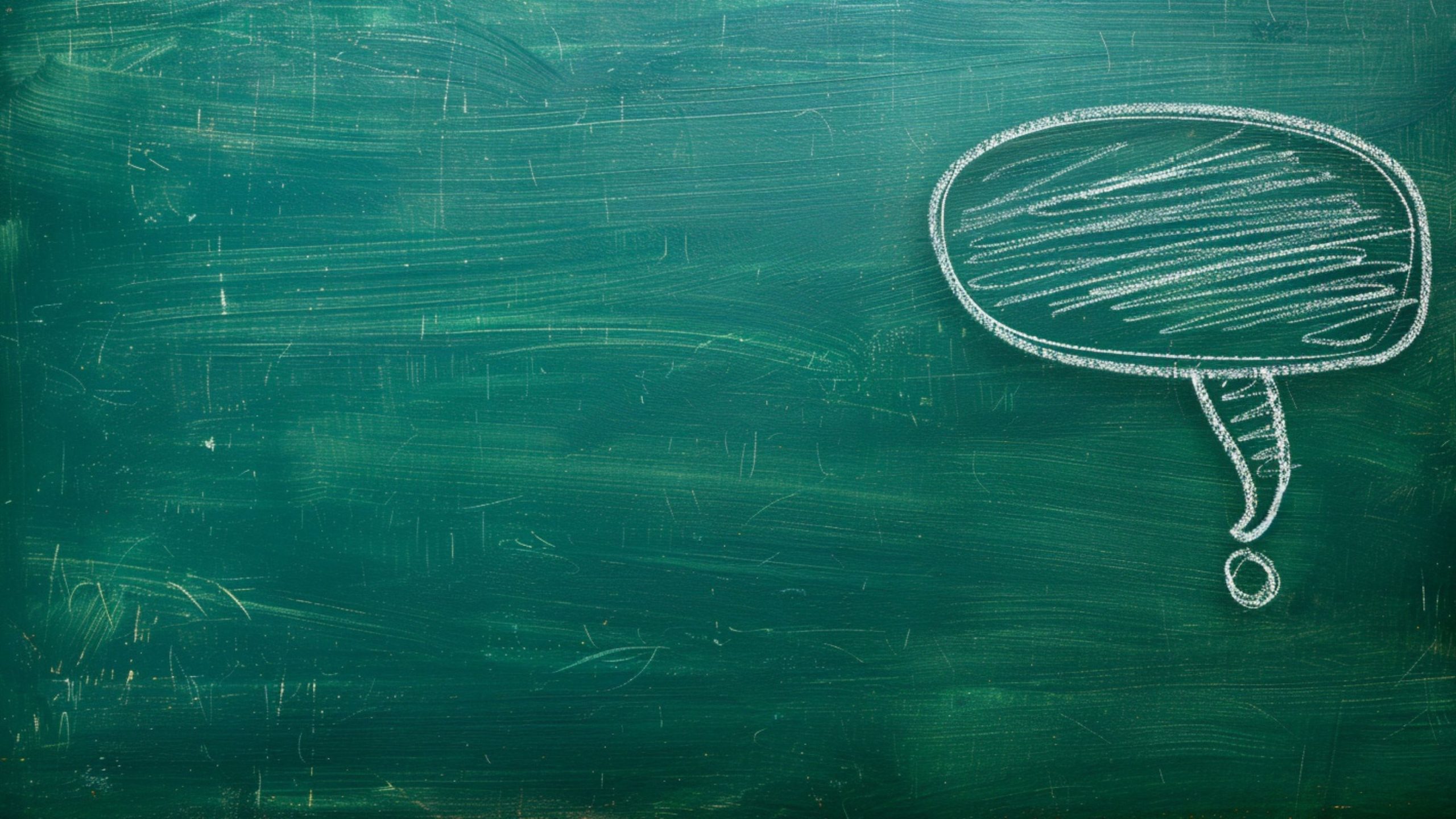 Green chalkboard with a white chalk-drawn speech bubble in the upper right corner, filled with scribbles.