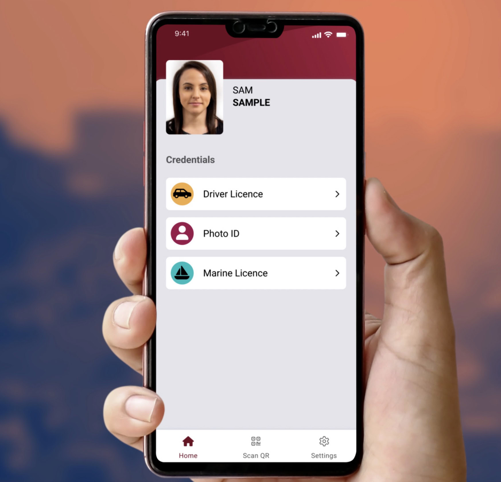 Hand holding phone showing digital ID app with profile Sam Sample and three credentials: Driver, Photo ID, and Marine licence