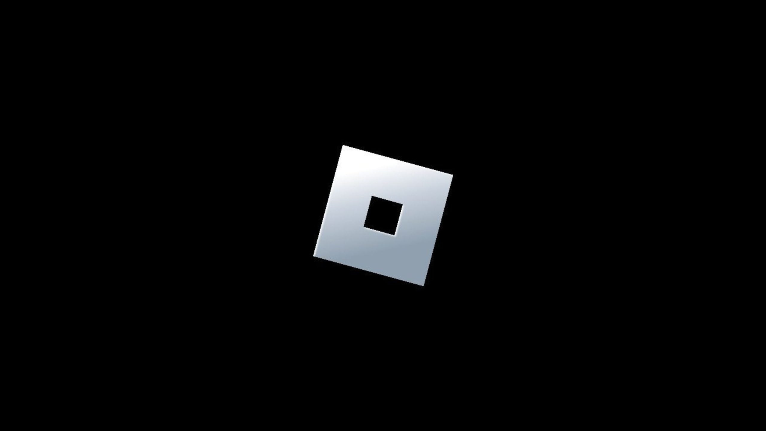 Tilted metallic silver square with a smaller square cutout in its center on a black background