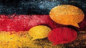 Abstract textured German flag colors with large yellow and red speech-bubble shapes and paint splatter effects