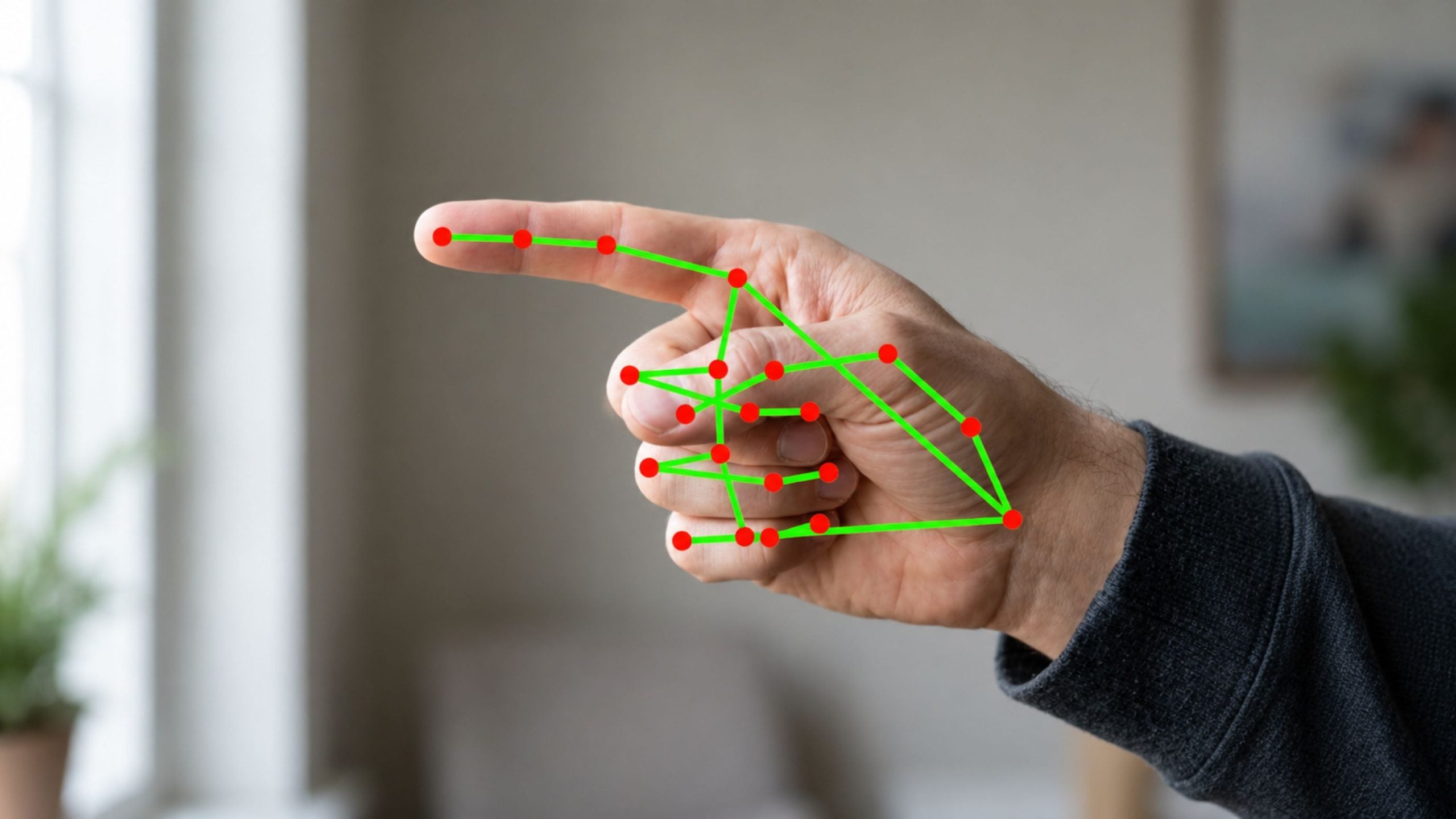 Right hand pointing forward with green skeletal lines and red joint dots overlaid on the fingers and palm.