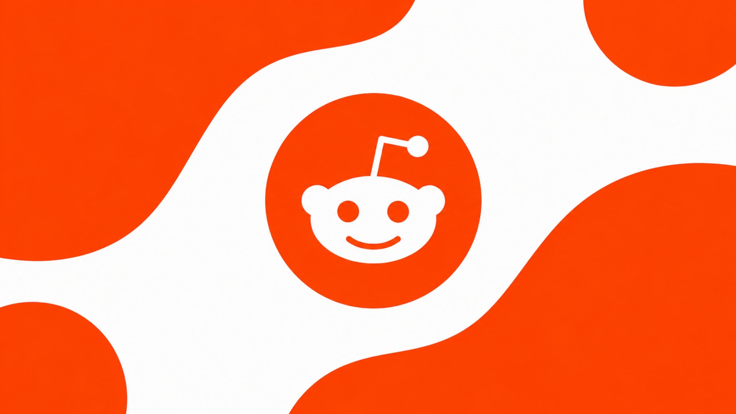 Red Reddit logo on a white background with orange abstract shapes