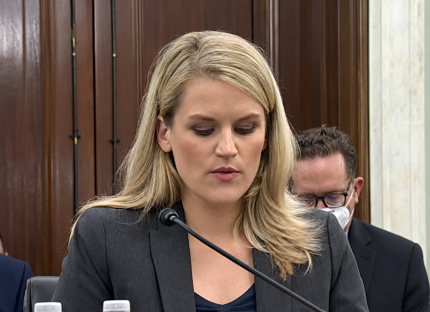 Facebook whistleblower Frances Haugen speaks into a microphone during a congressional hearing.